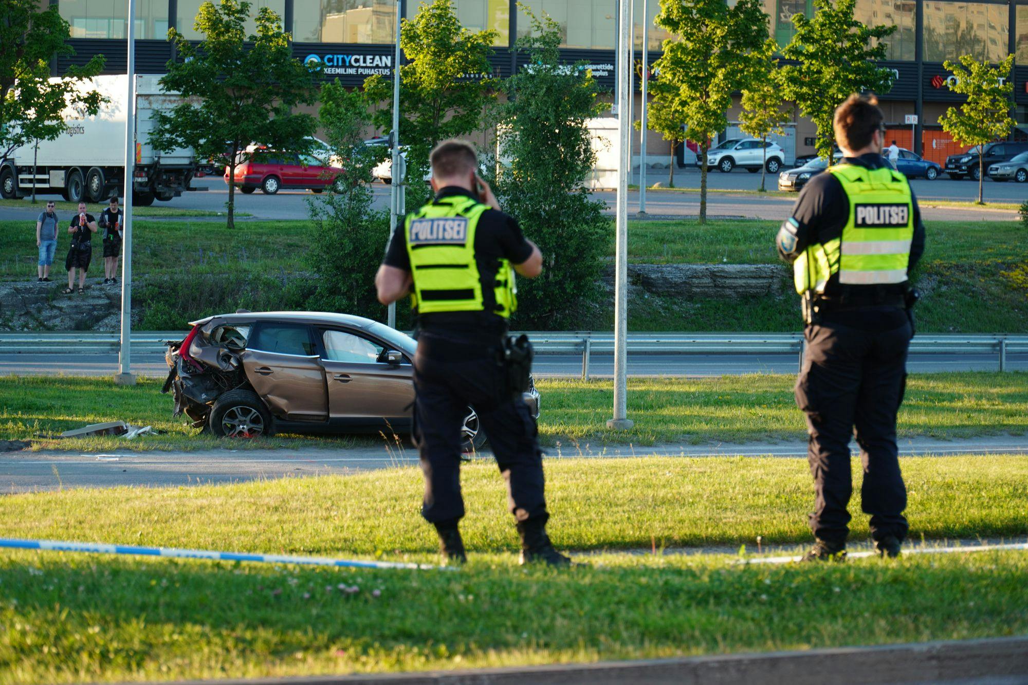 Two police offers in front of a car accident